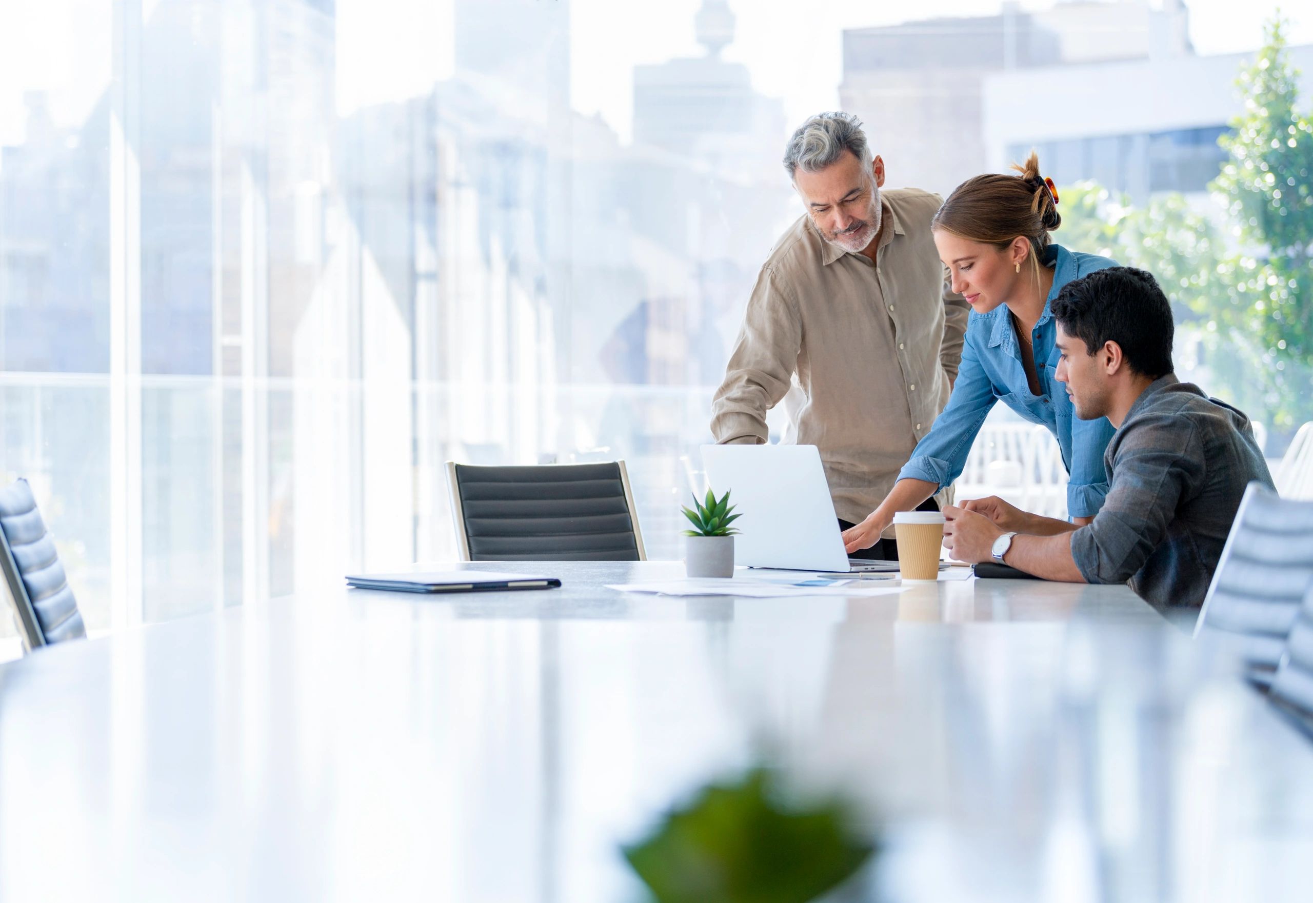 Business team reviewing work on a laptop