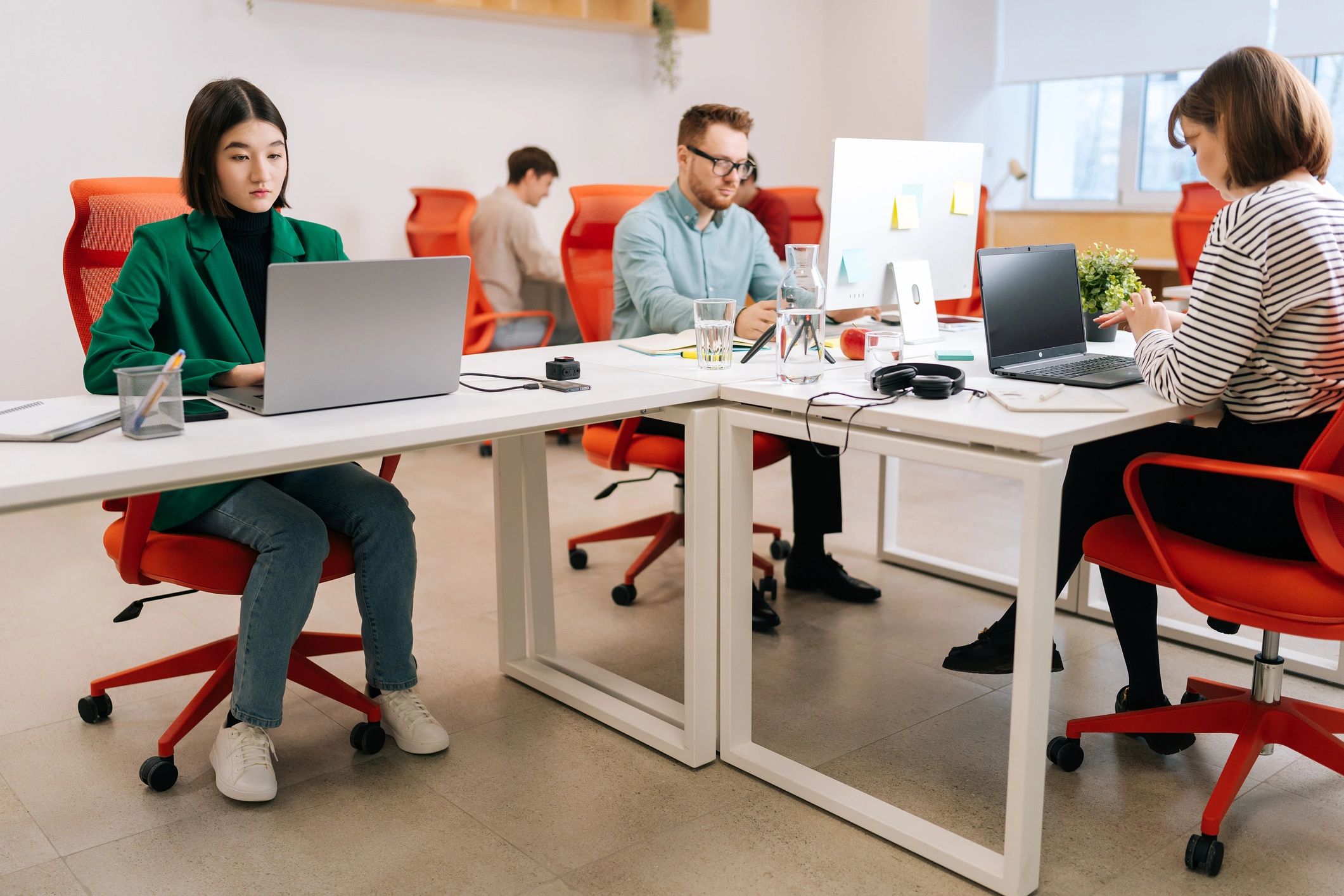 Small team collaborating around a laptop in an office