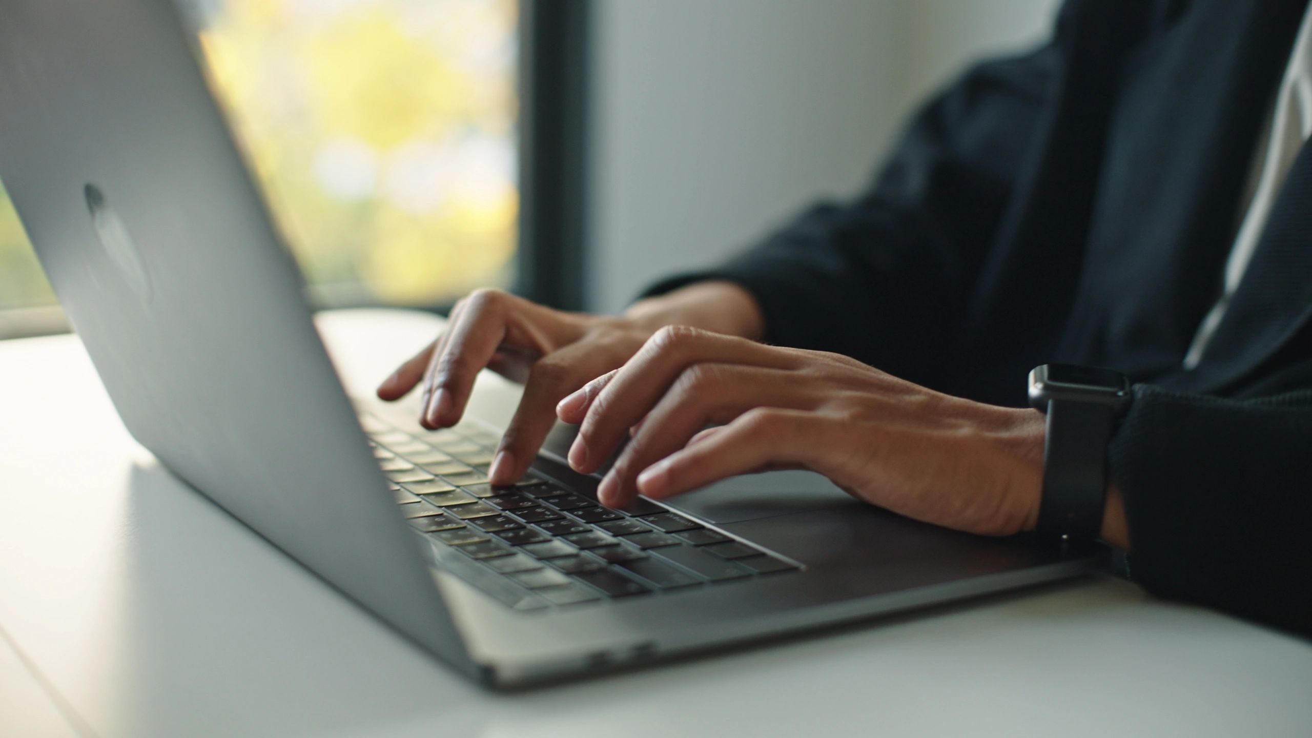 Person typing an email campaign on a laptop